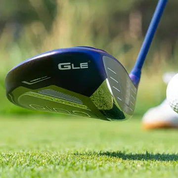 Golfeuse au départ frappant avec un driver de golf femme sur un parcours